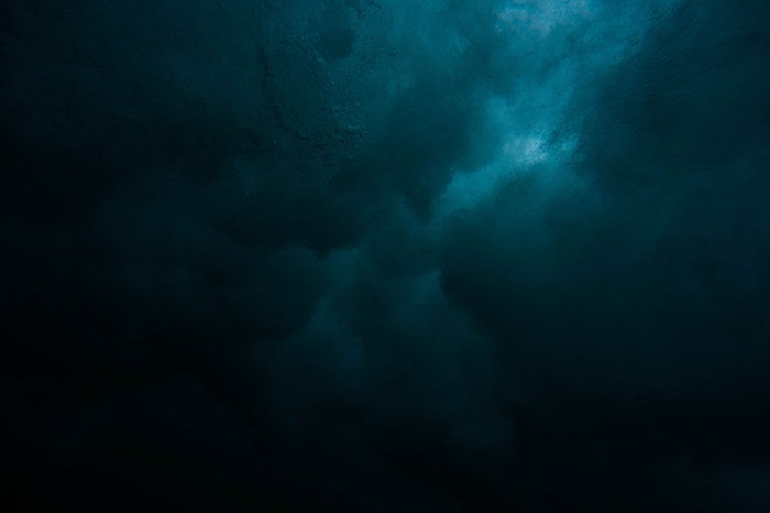 looking up through the dark ocean to the sky